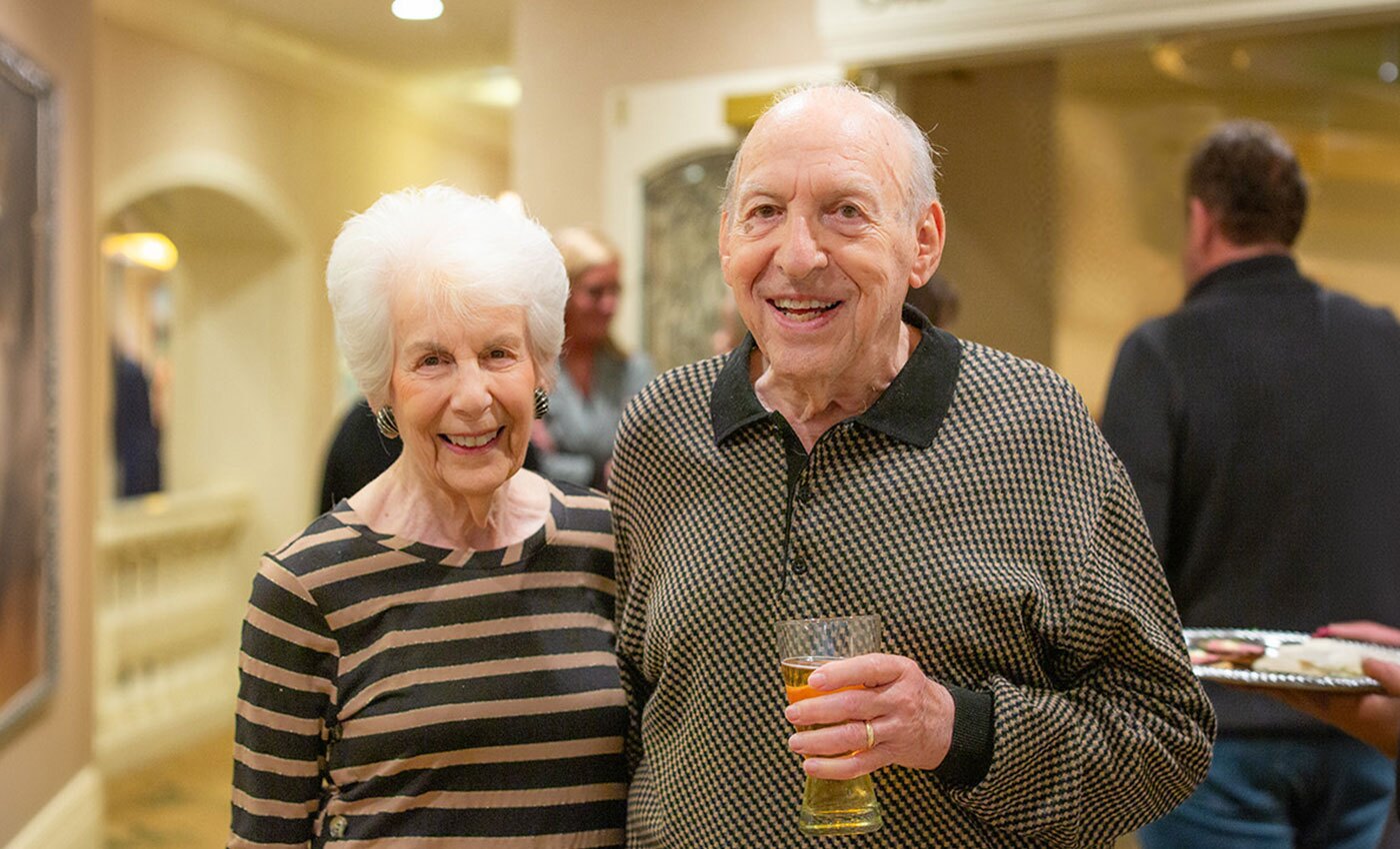 Resident couple with drinks at an event.