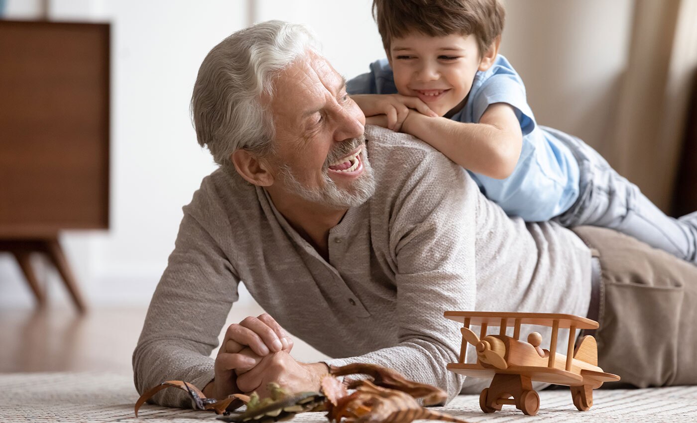 The Gatesworth grandfather and grandson playing with toys.