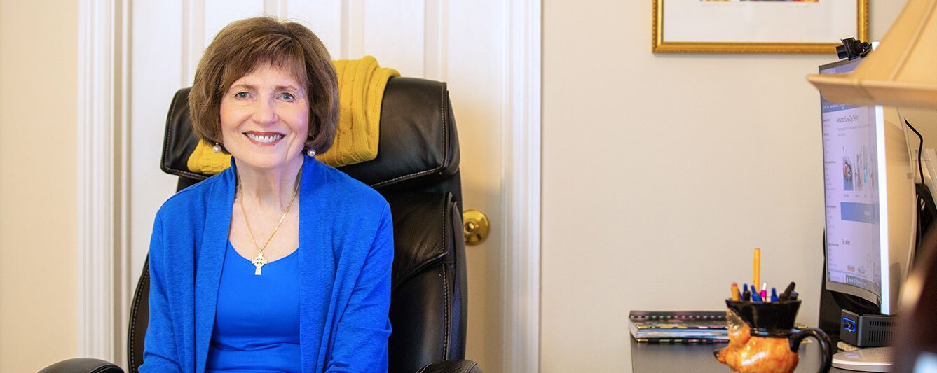 A resident seated with her computer.