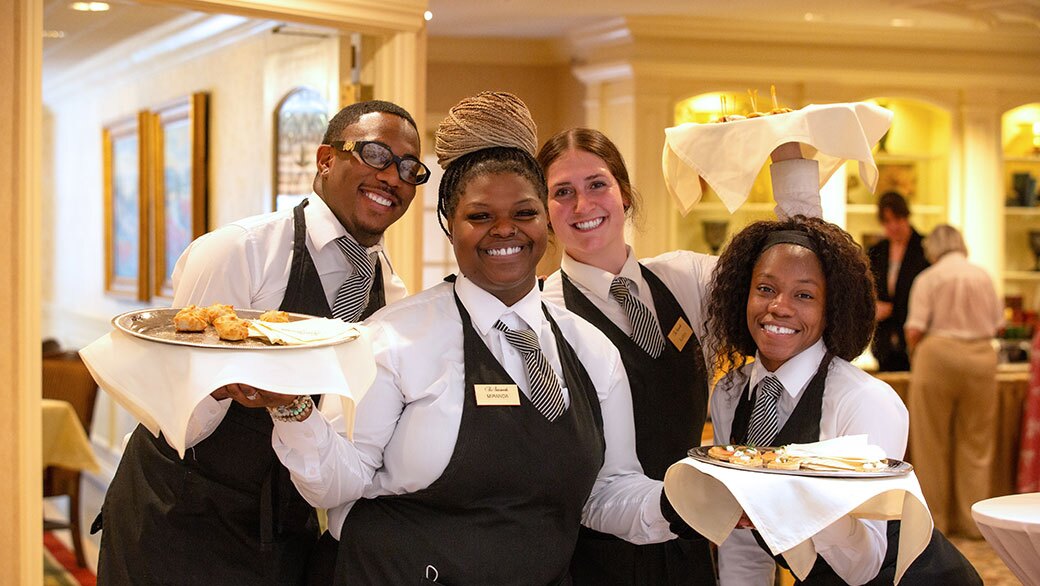 The Gatesworth wait staff posing together with food.