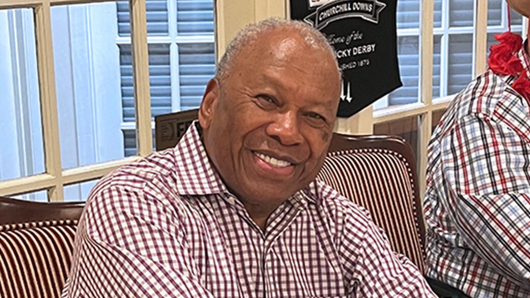 Floyd Lewis seated and smiling.