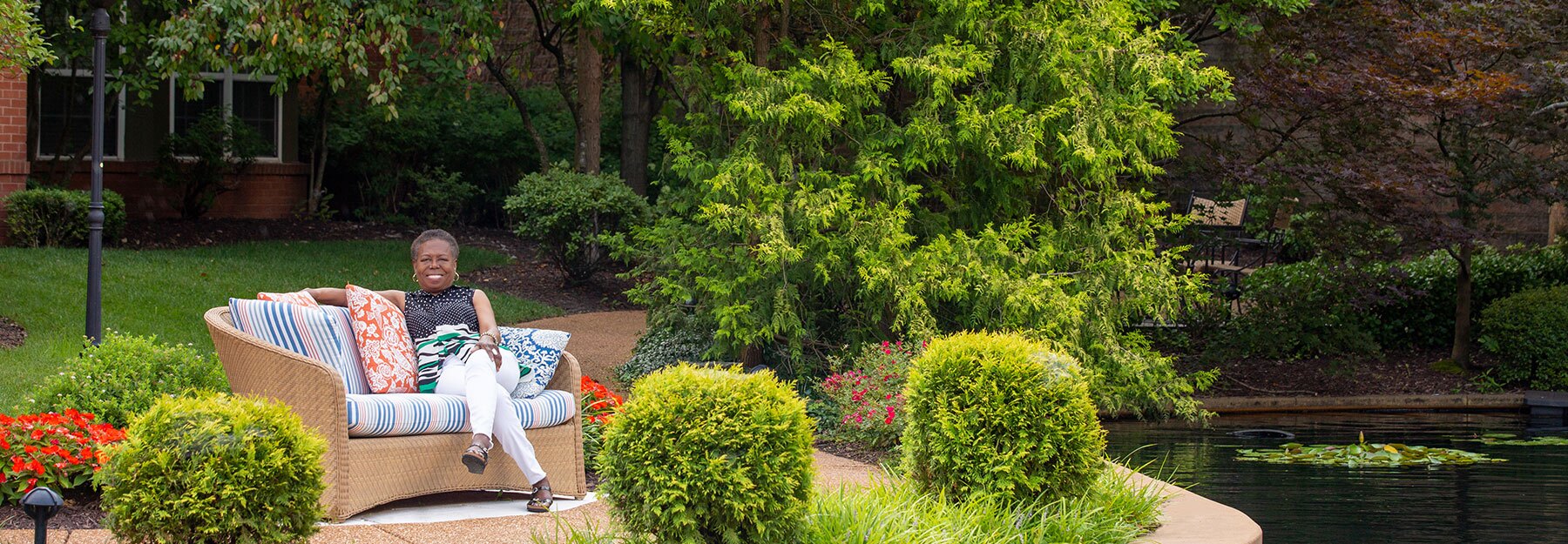 The Gatesworth Dr. Pasley sitting outside next to pond.