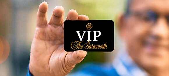 A man holding a Gatesworth VIP card.