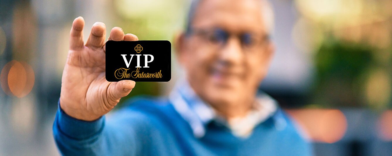 A man holding a Gatesworth VIP card.