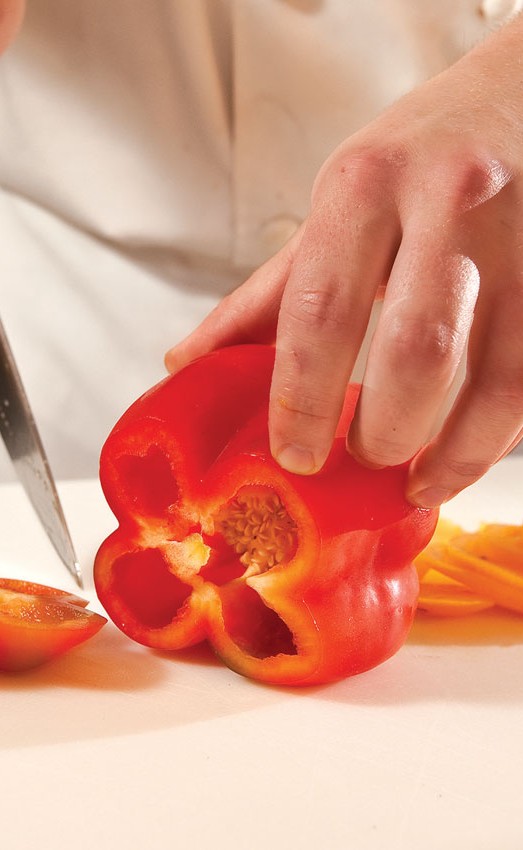 Chef chopping red bell pepper