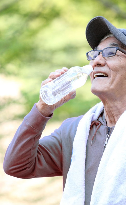 A man drinks water after outdoor activities