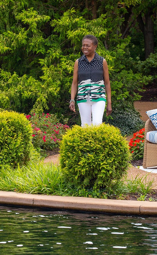 Resident admiring the pond outdoors.