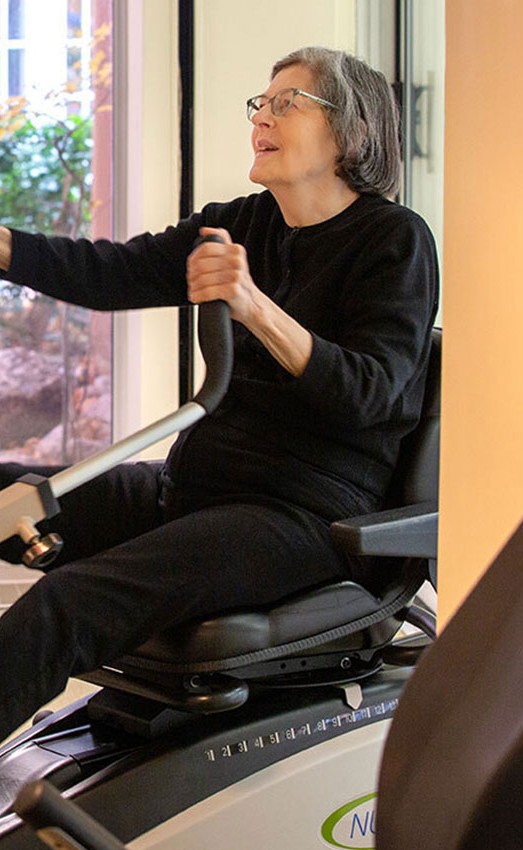 Resident in the gym on exercise machine.