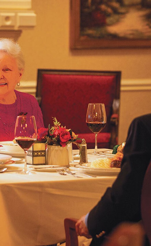 Four residents sitting at the dinner table.