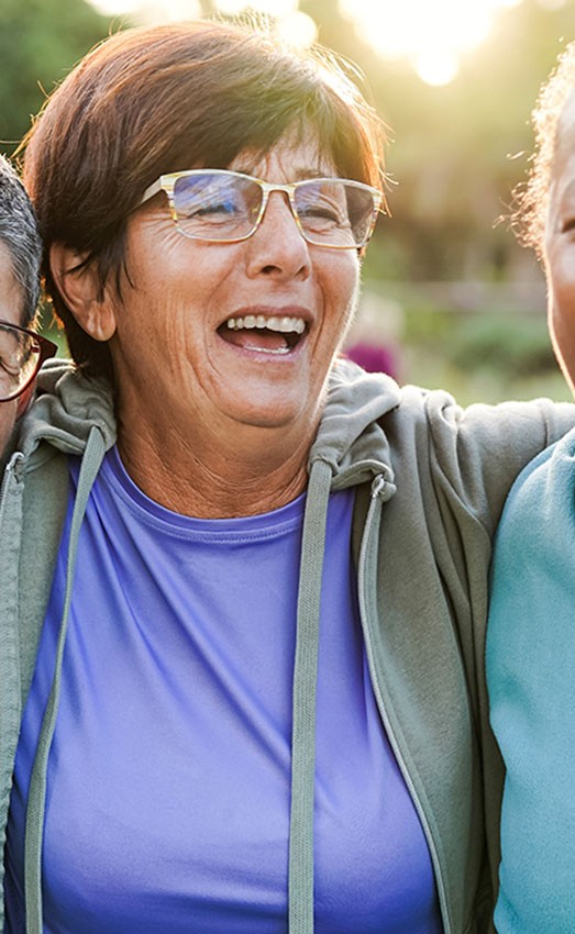 Three women smiling and laughing.