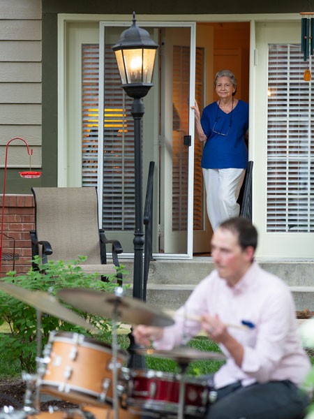 Resident watching a drummer perform from a distance