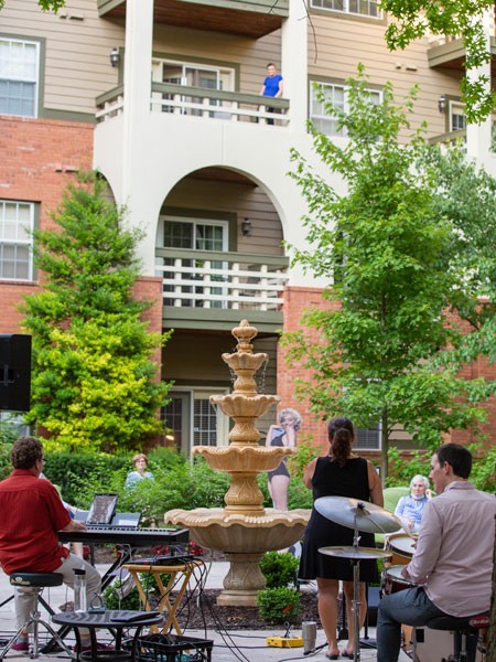 Residents watch performers next to fountain
