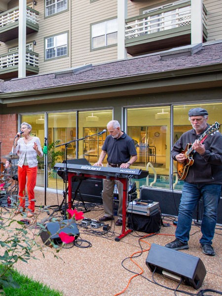 Band playing music outside in courtyard