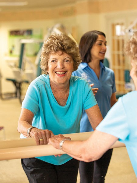 Resident in front of a mirror during fitness class.