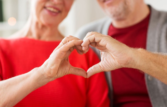 A couple making a heart shape with their hands to showcase heart health at The Gatesworth