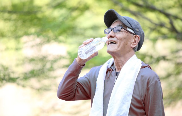 A man drinks water after outdoor activities