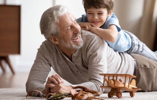 The Gatesworth grandfather and grandson playing with toys.