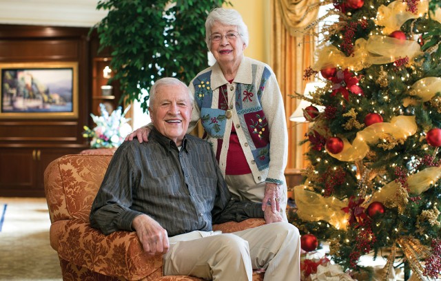 The Gatesworth couple with a Christmas tree.