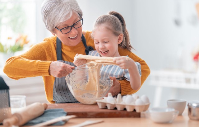 Grandmother and granddaughter baking in the kitchen.