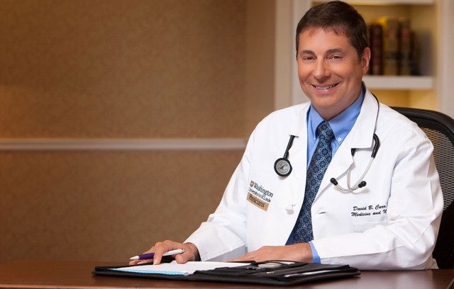 Dr. Carr sitting at a desk.