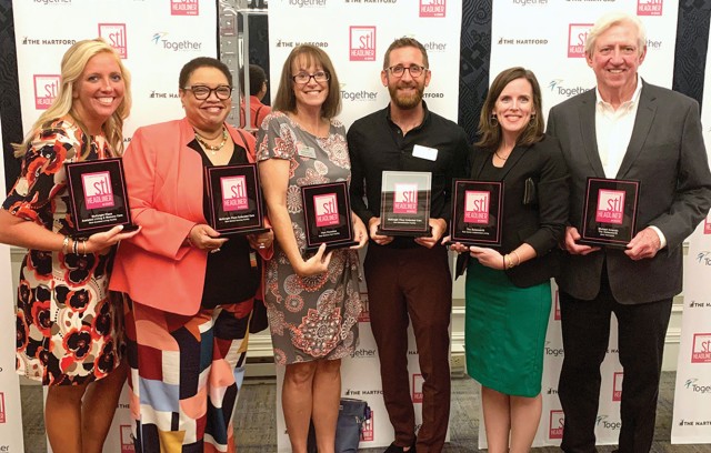 Staff from The Gatesworth pose with STL Headliners plaques.