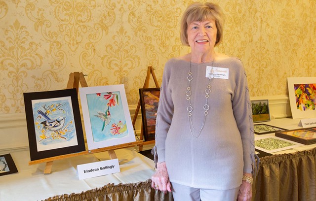 Erladean Mattingly standing with her artwork.