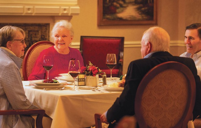 Four residents sitting at the dinner table.