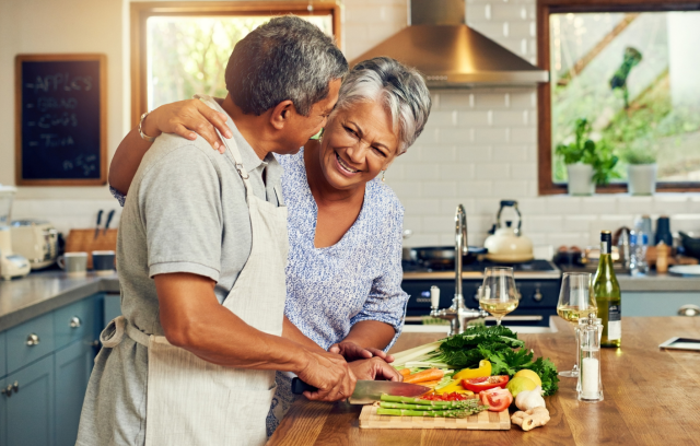 elderly couple cooking together
