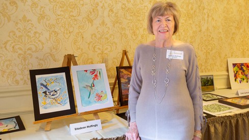 Erladean Mattingly standing with her artwork.