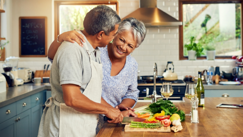 elderly couple cooking together