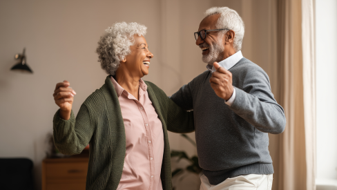 senior couple dancing in their home