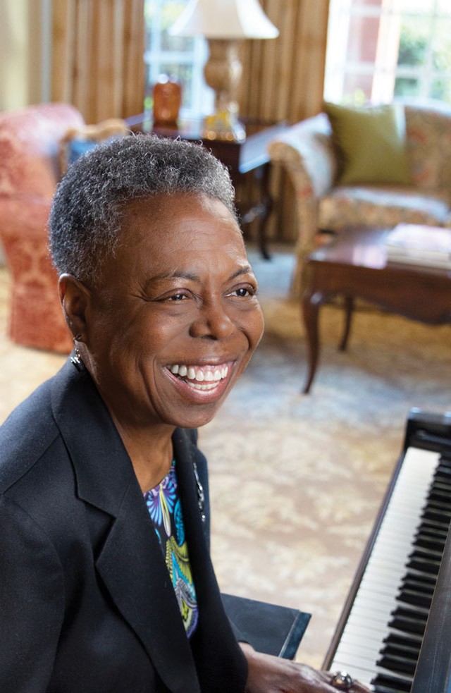Woman playing the piano and smiling