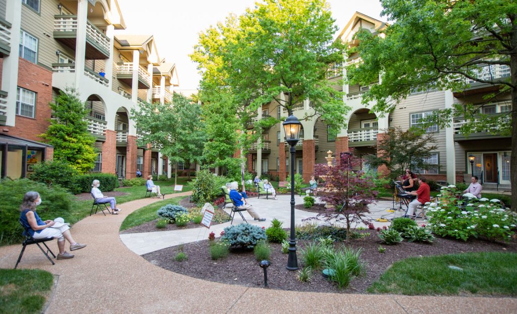 Residents socially distant outdoors watching a concert