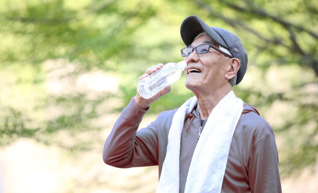 A man drinks water after outdoor activities