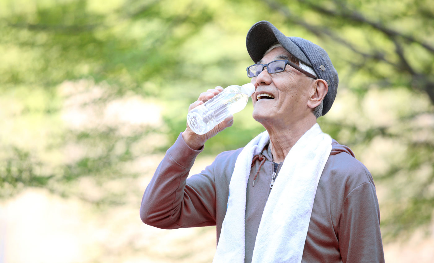 A man drinks water after outdoor activities