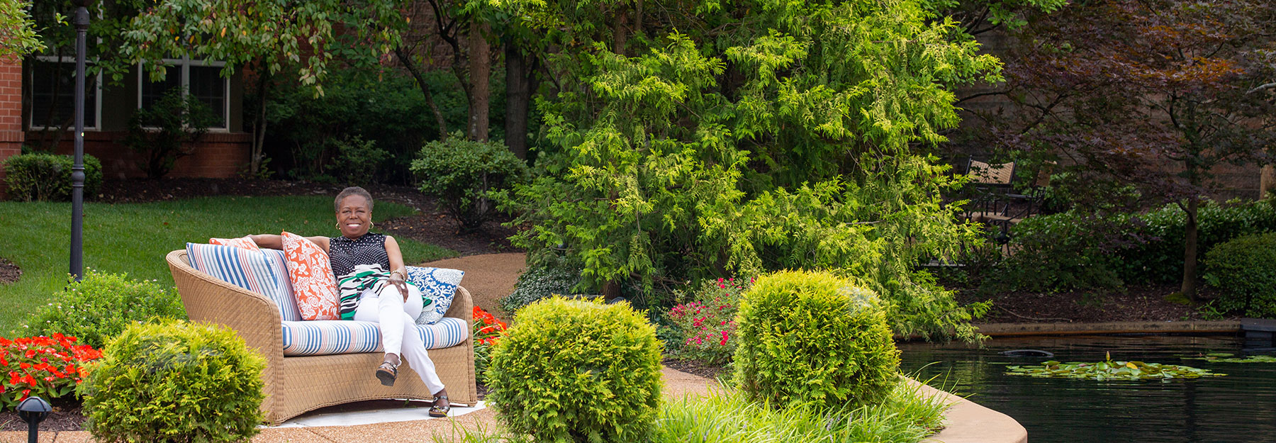 The Gatesworth Dr. Pasley sitting outside next to pond.
