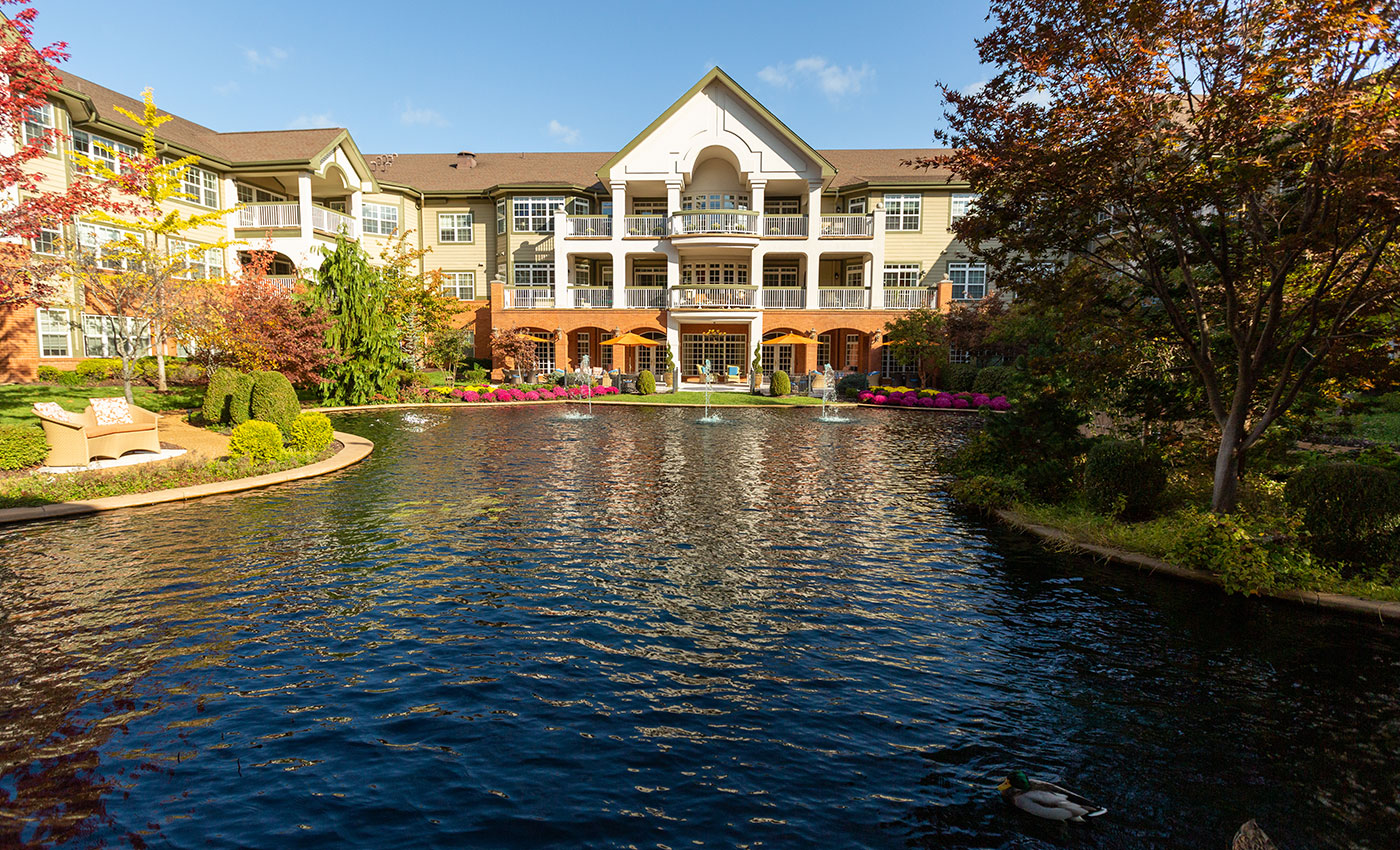 The Gatesworth pond with trees in various fall colors.