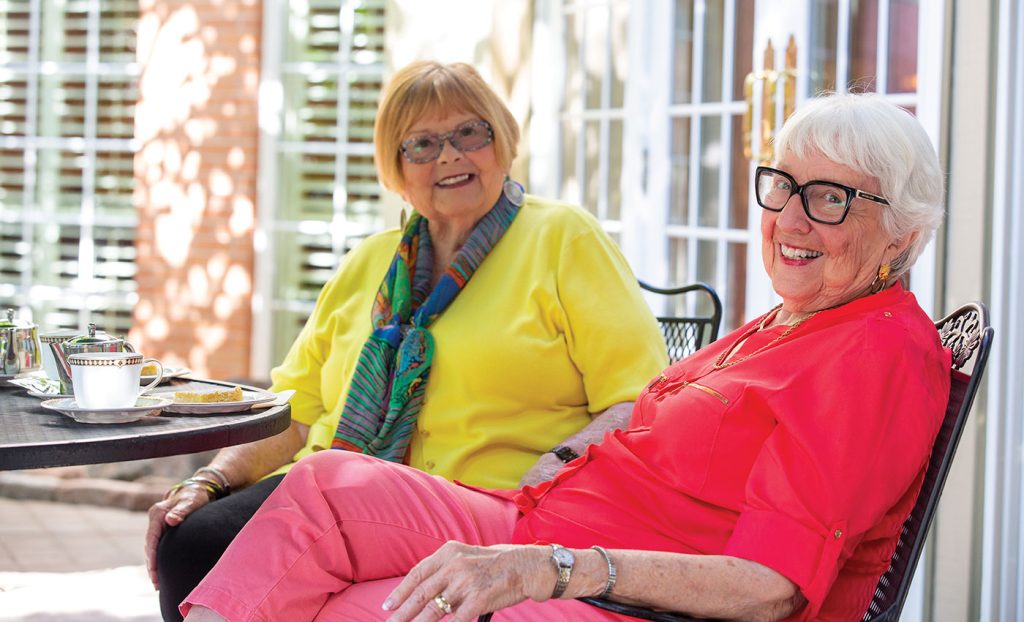 The Gatesworth residents sitting outside with tea.