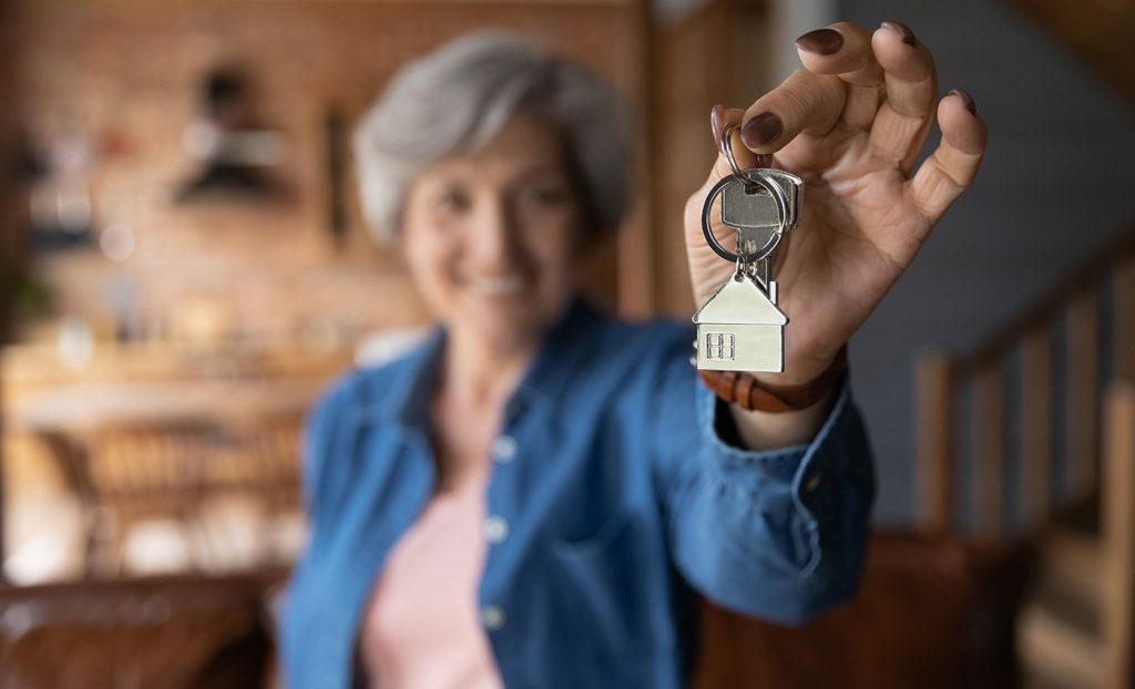The Gatesworth woman holding a key up close.