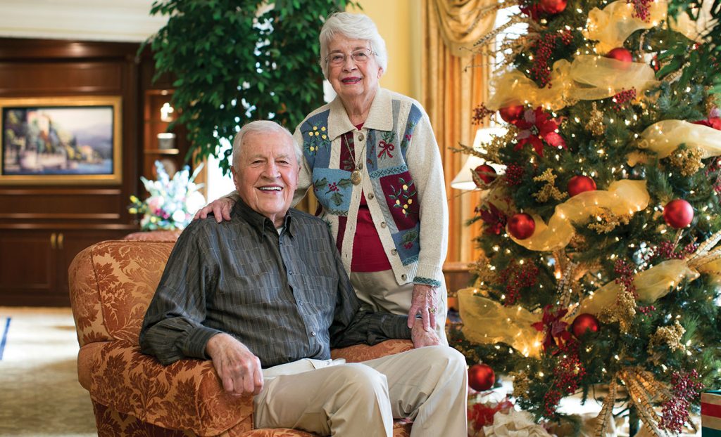 The Gatesworth couple with a Christmas tree.