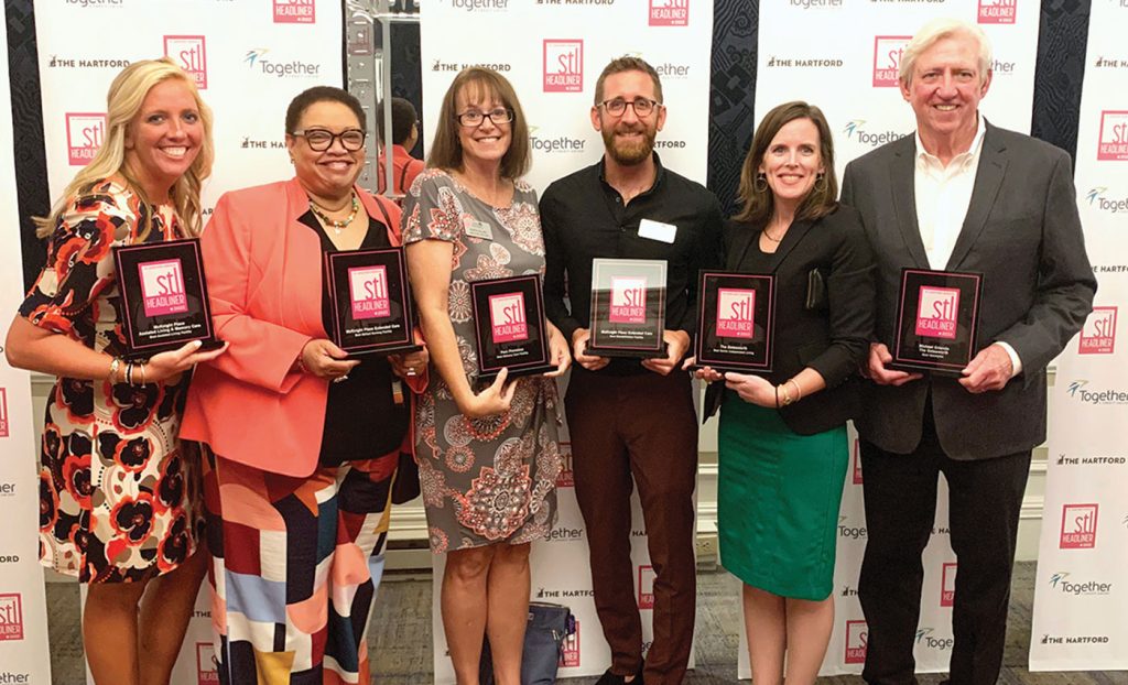 Staff from The Gatesworth pose with STL Headliners plaques.