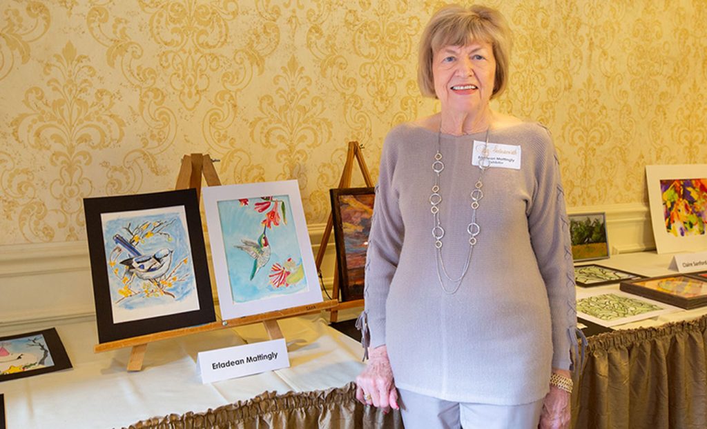 Erladean Mattingly standing with her artwork.