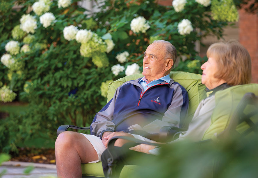 A man and woman sitting outside.