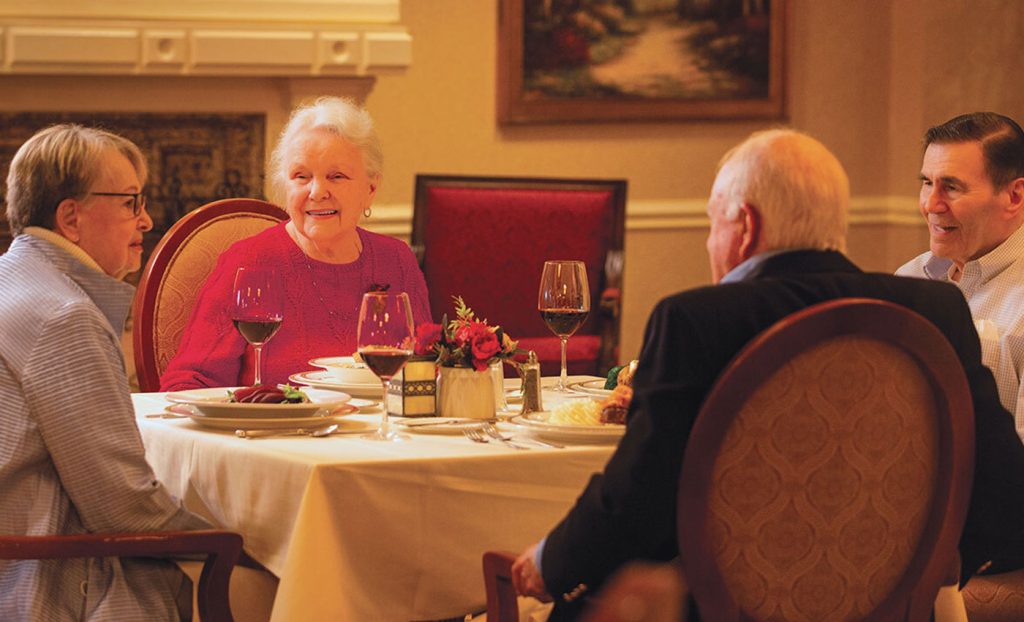 Four residents sitting at the dinner table.