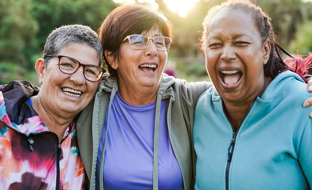 Three women smiling and laughing.