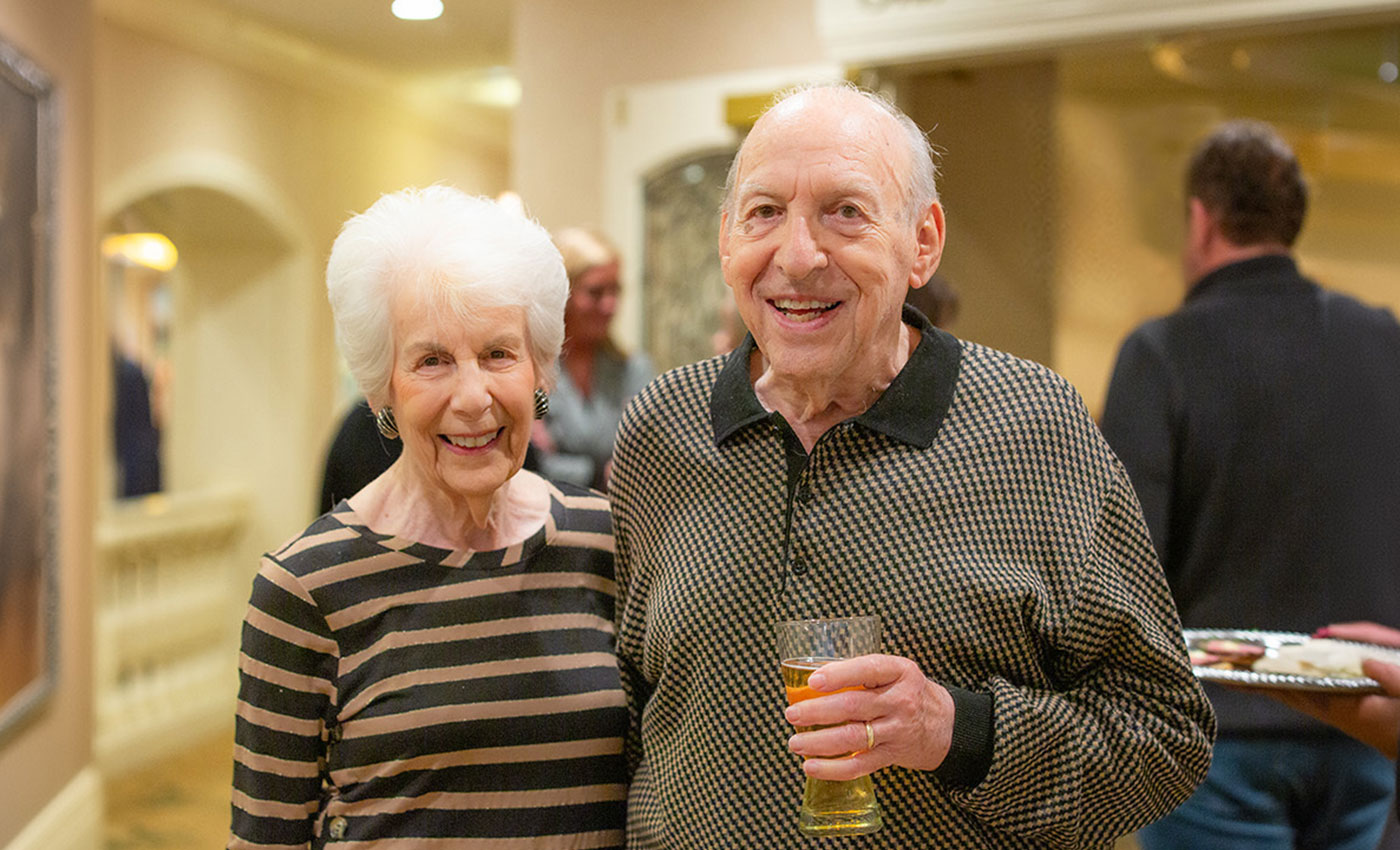 Resident couple with drinks at an event.